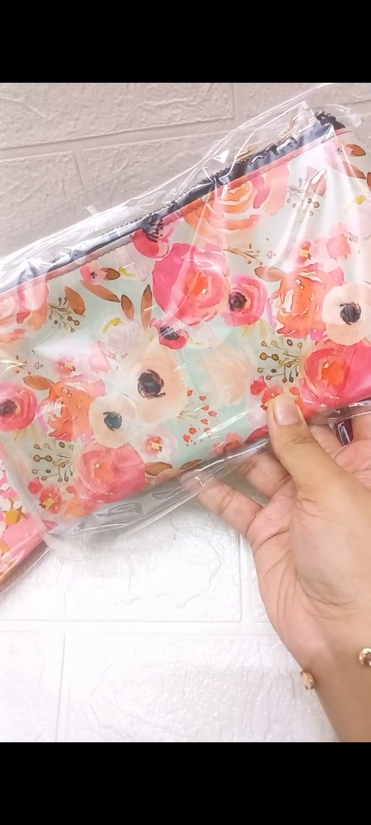 A real mint custom pouch printed with large coral, pink, peach, and white watercolour roses