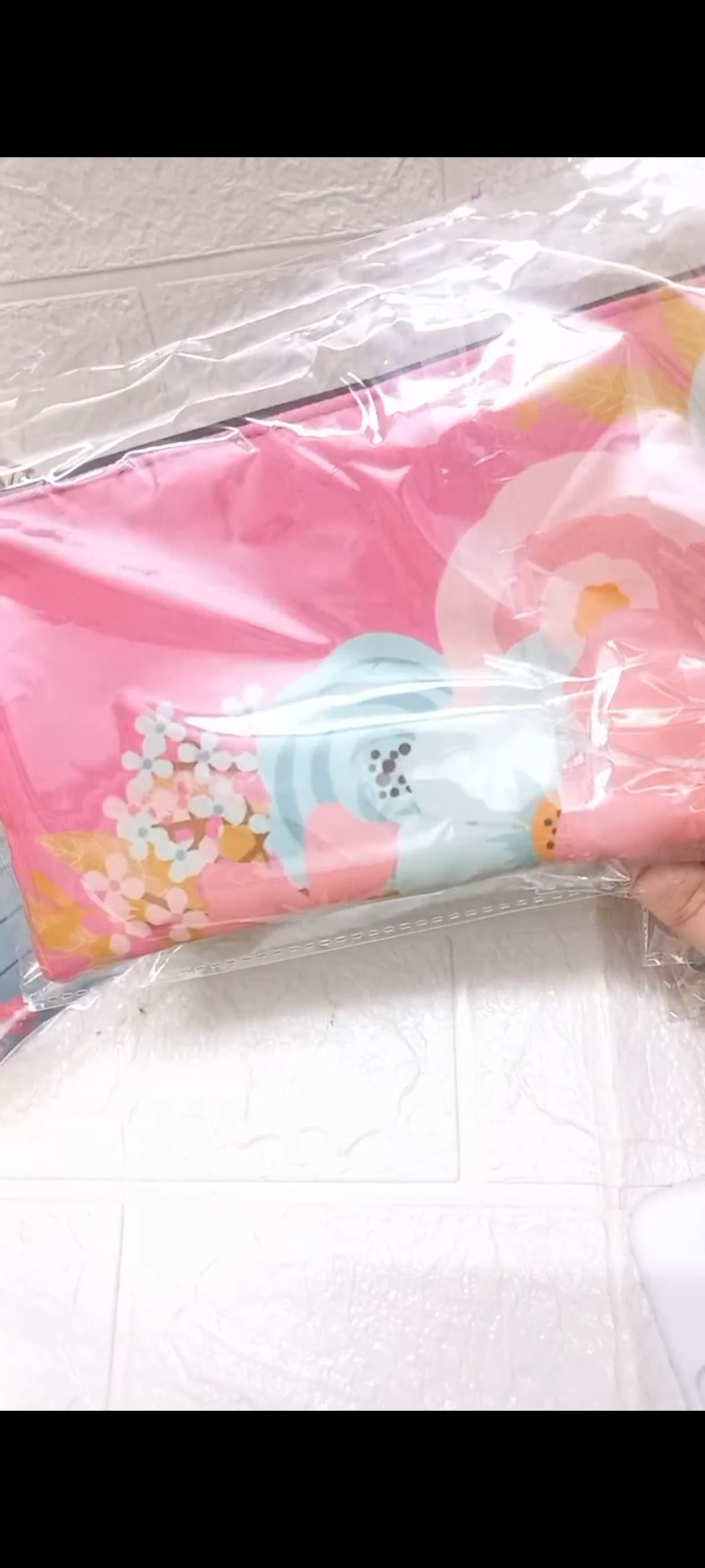 A real vivid pink custom pouch with oversized abstract blue, peach, white, and yellow flowers